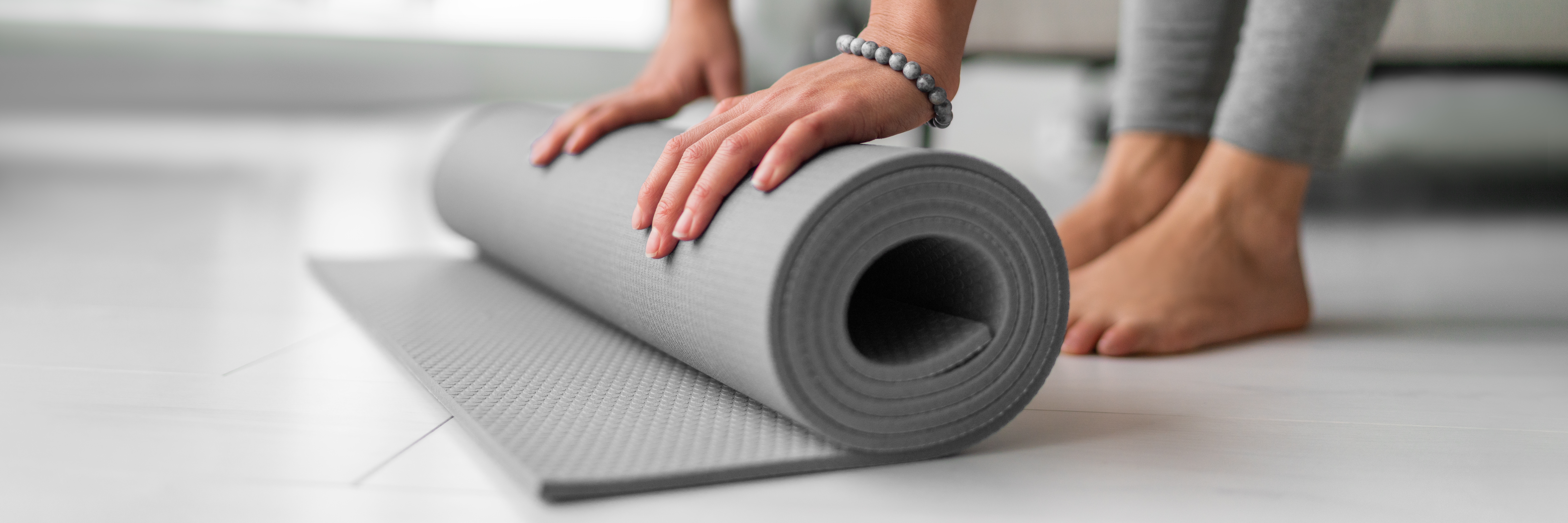 Yoga,Online,Class,At,Home,Woman,Rolling,Mat,On,Apartment